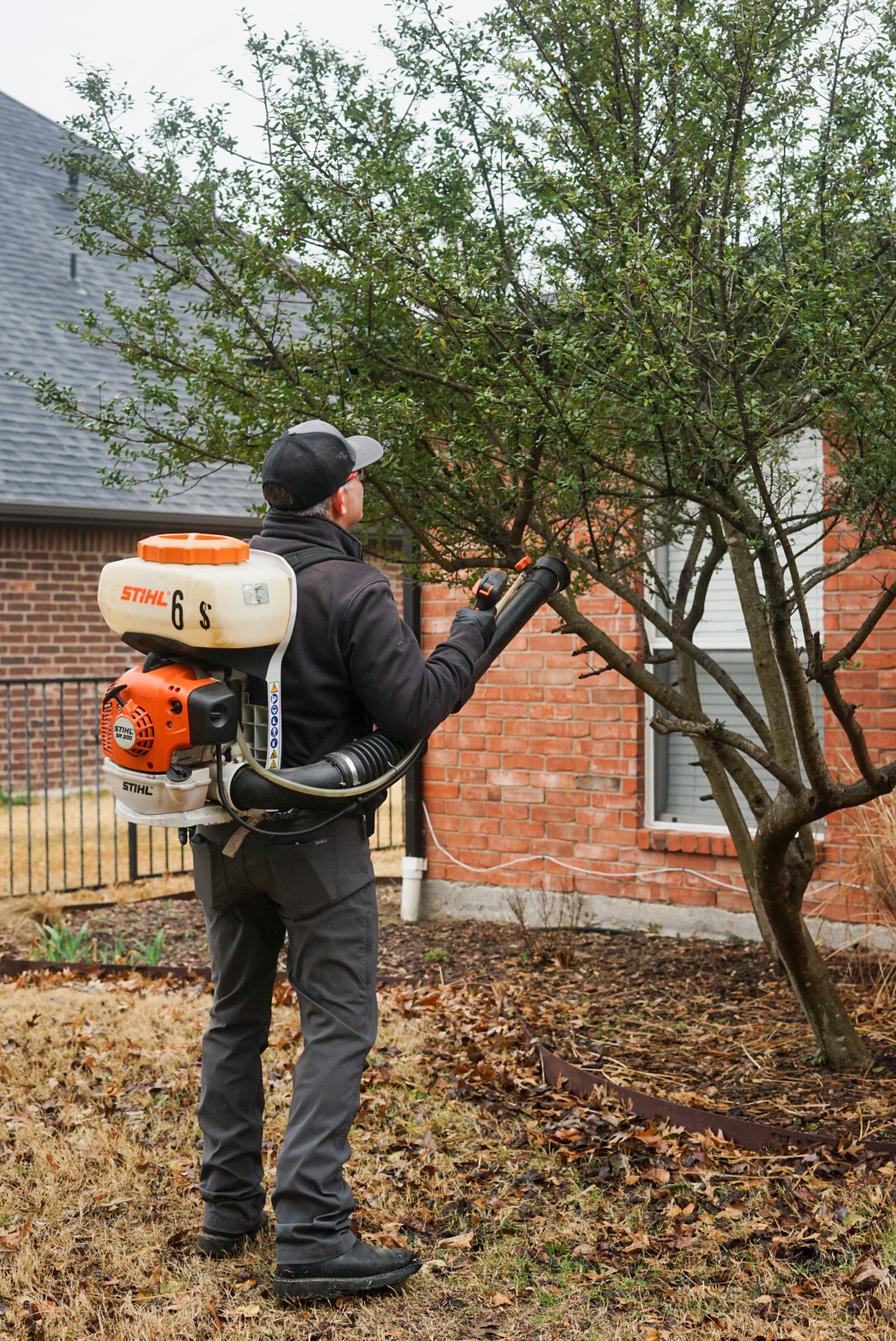 pest control professional treating an exterior